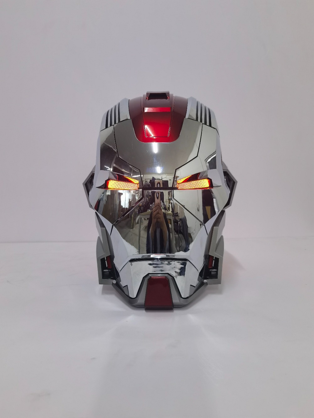 Futuristic electronic Iron Man helmet with remote sound effects and glowing LED eyes, coolest geek desk setup ornament.