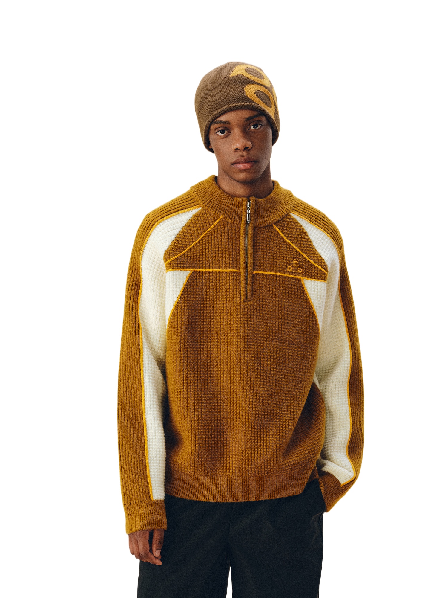 A young man models the EastLyst Color Block Half Zip Sweater, featuring brown wool with white geometric panels—ideal for premium autumn-winter warmth and style.