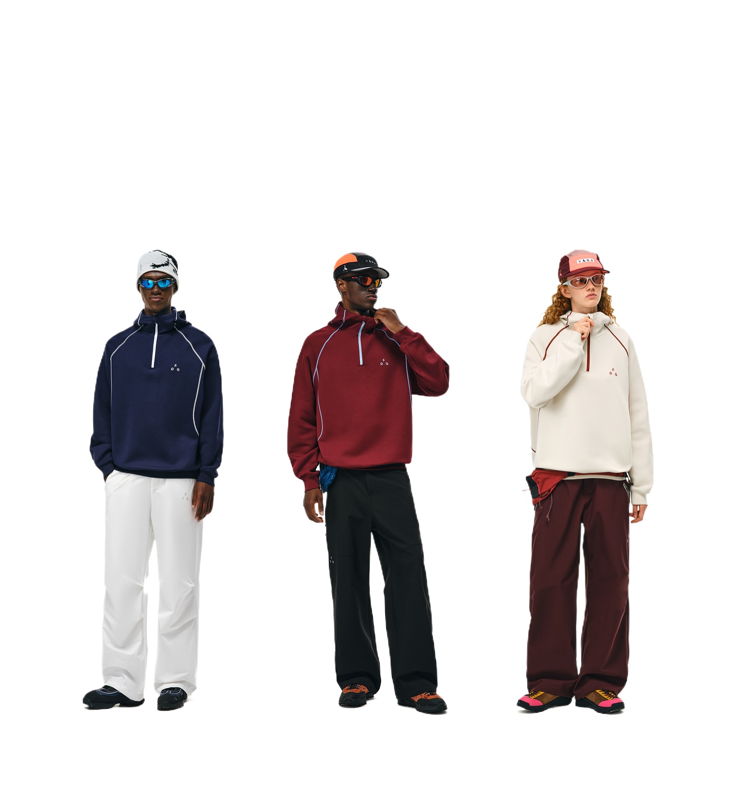 Three people wear EastLyst Retro-Core Half-Zip Hoodies: one navy with white pants, one burgundy with black pants, and one cream with burgundy pants. All pair their sporty, skin-friendly outfits with hats and sunglasses.