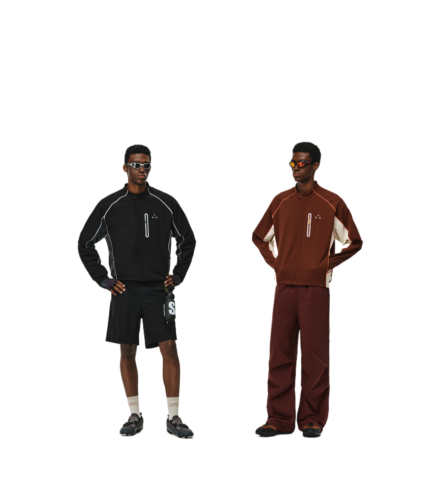 Two men stand side by side against a white background. One wears the EastLyst Contrast Color Jacket with black shorts and sunglasses; the other sports a brown zip-up, matching pants, black shoes, and sunglasses—both ready for outdoor adventures.